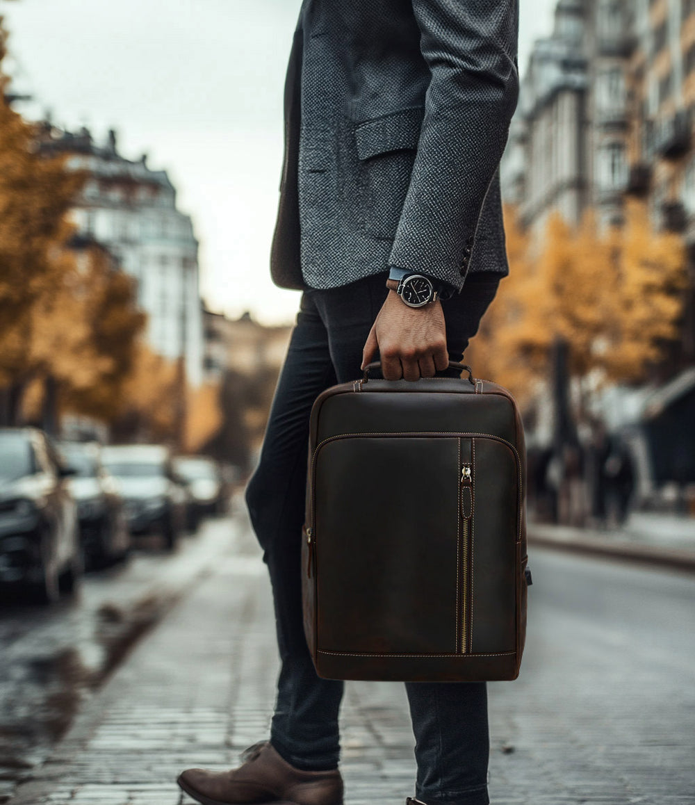 Man walking with a stylish Crazy Horse leather backpack in an urban setting.
