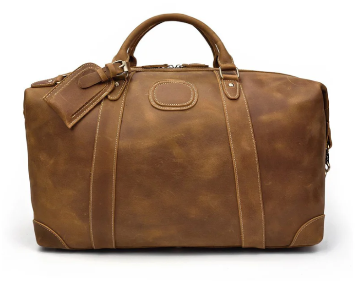 Leather holdall bag in rich brown, perfect for travel and adventure in the Swiss Alps.