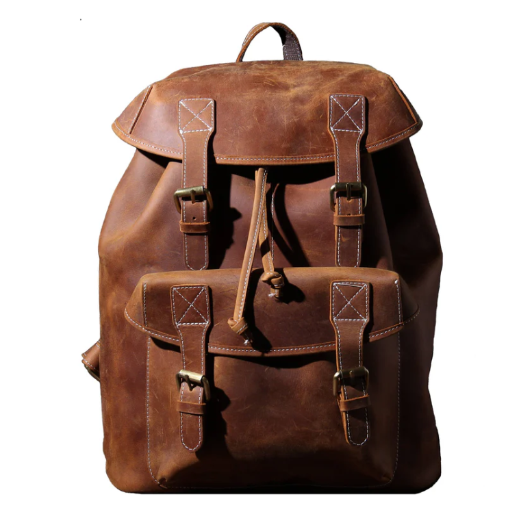 Stylish leather knapsack in rich brown color, featuring adjustable straps and multiple pockets for storage.