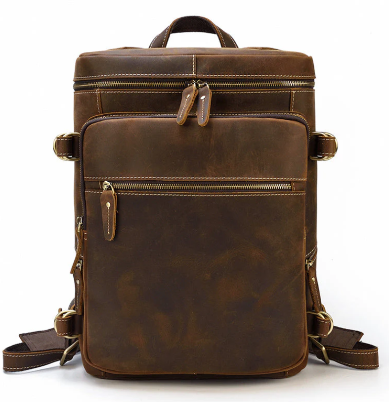 Leather rucksack backpack in rich brown color, featuring multiple zippers and pockets, ideal for travel and daily use.