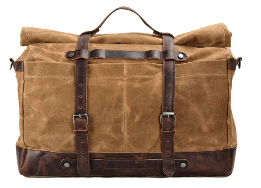 Waxed canvas duffle bag with leather accents, ideal for outdoor adventures and stylish travel.
