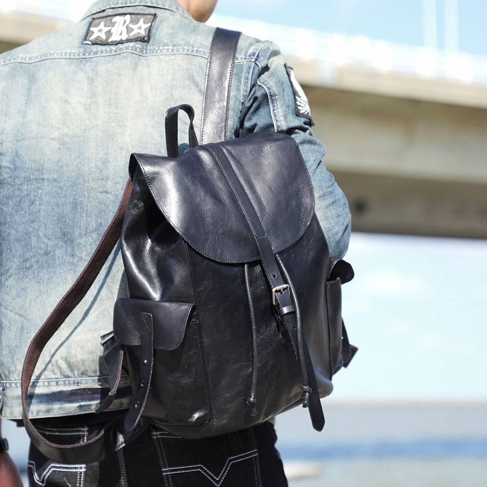 Stylish small black leather backpack showcased outdoors, ideal for adventures near Lake Victoria.