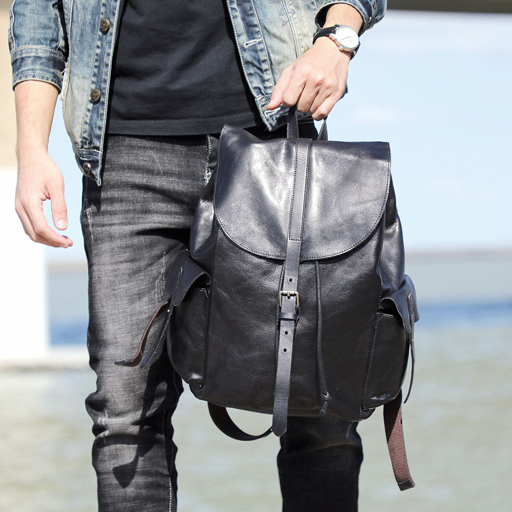 Man carrying a stylish small black leather backpack, perfect for everyday use, by Lake Victoria.