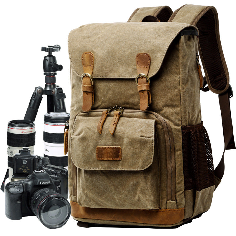Waterproof canvas camera backpack with tripod, DSLR camera, and lenses, ideal for photography in any environment.