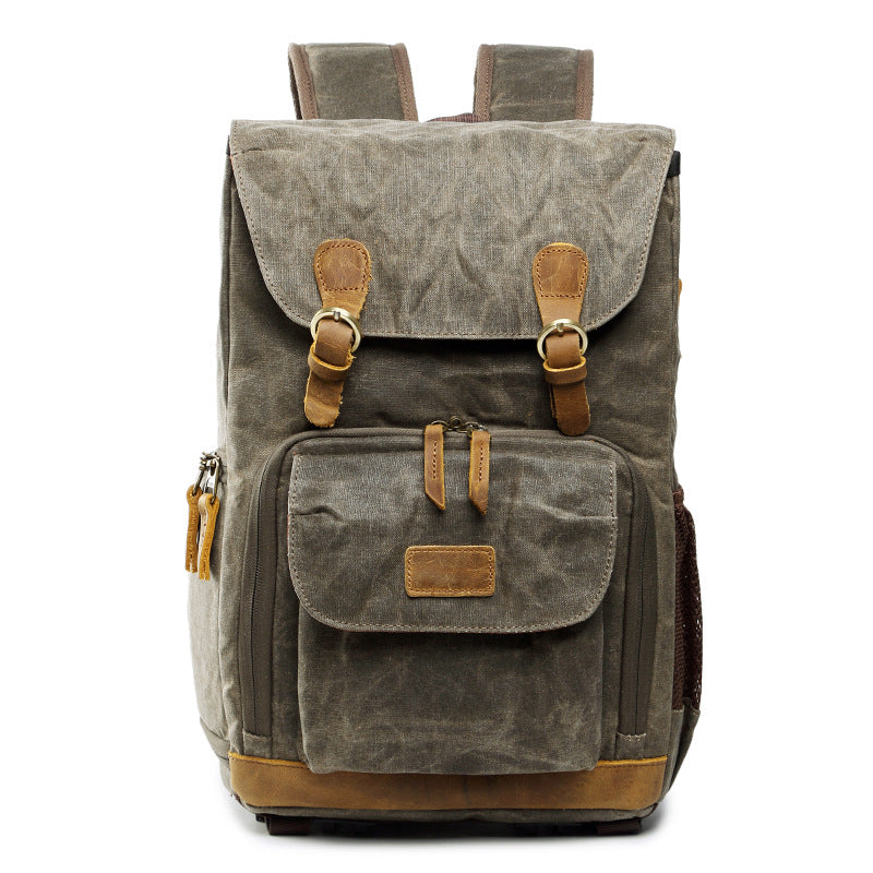 Waterproof canvas camera backpack in gray with leather accents, ideal for outdoor photography adventures.