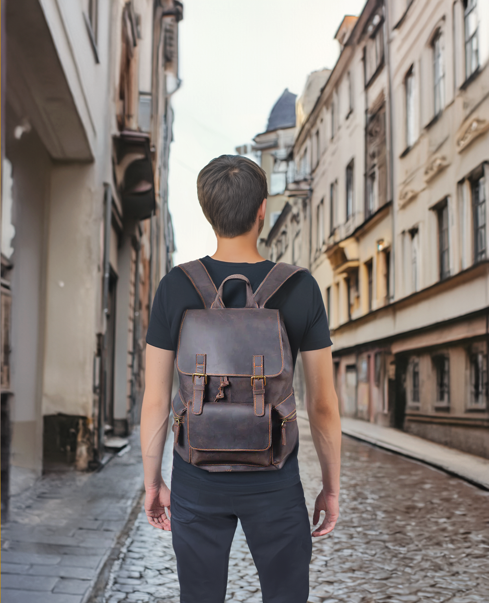 Man walking down a cobblestone street wearing a stylish leather drawstring backpack, showcasing urban fashion.