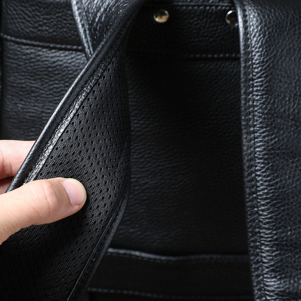 Interior view of a black leather bookbag showcasing its spacious compartments and durable texture.