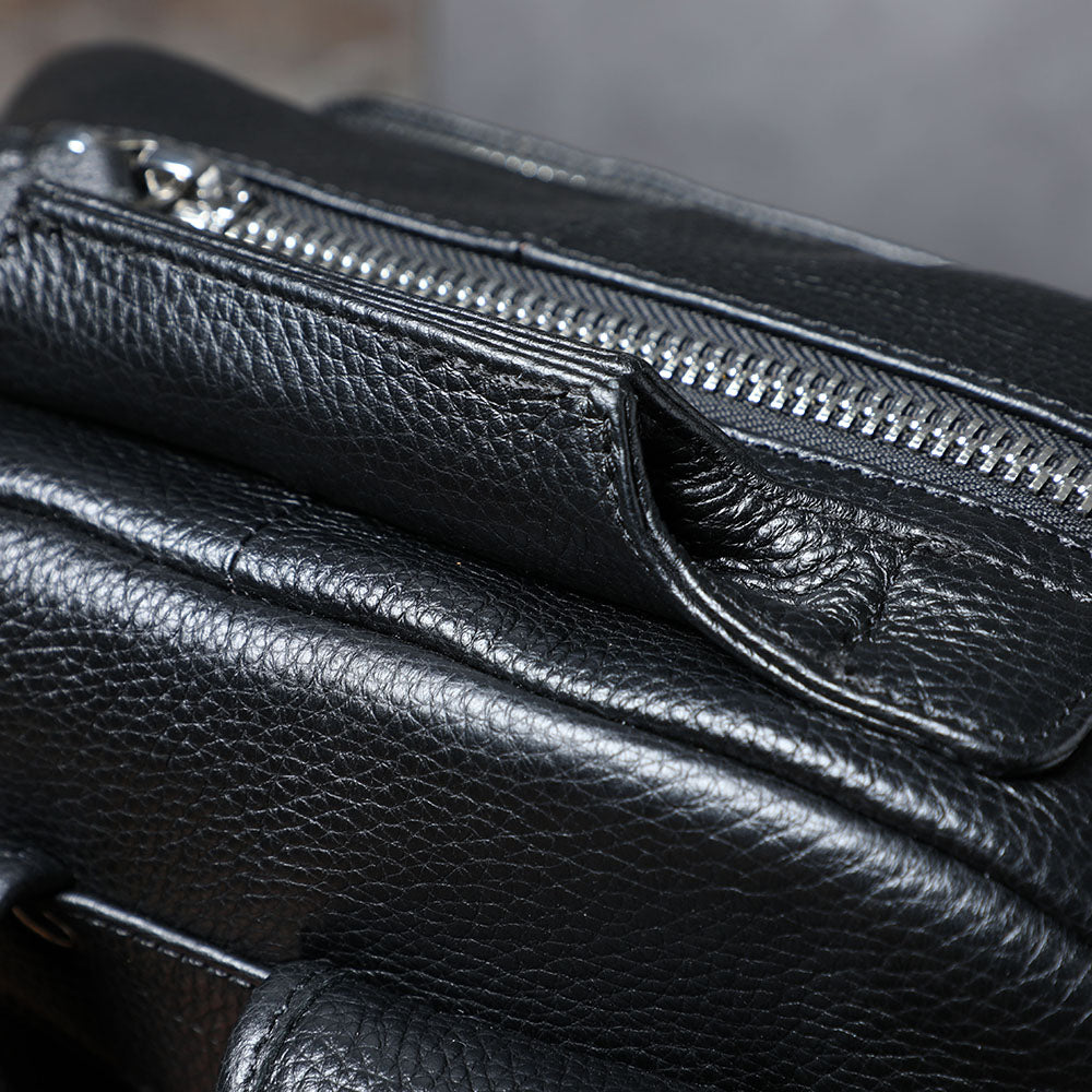 Close-up of the stylish black leather bookbag featuring a zippered pocket, ideal for any adventure.