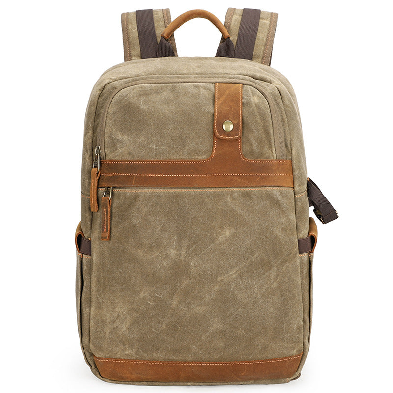 Stylish canvas photography backpack in khaki with leather accents, perfect for outdoor adventures and capturing memories.
