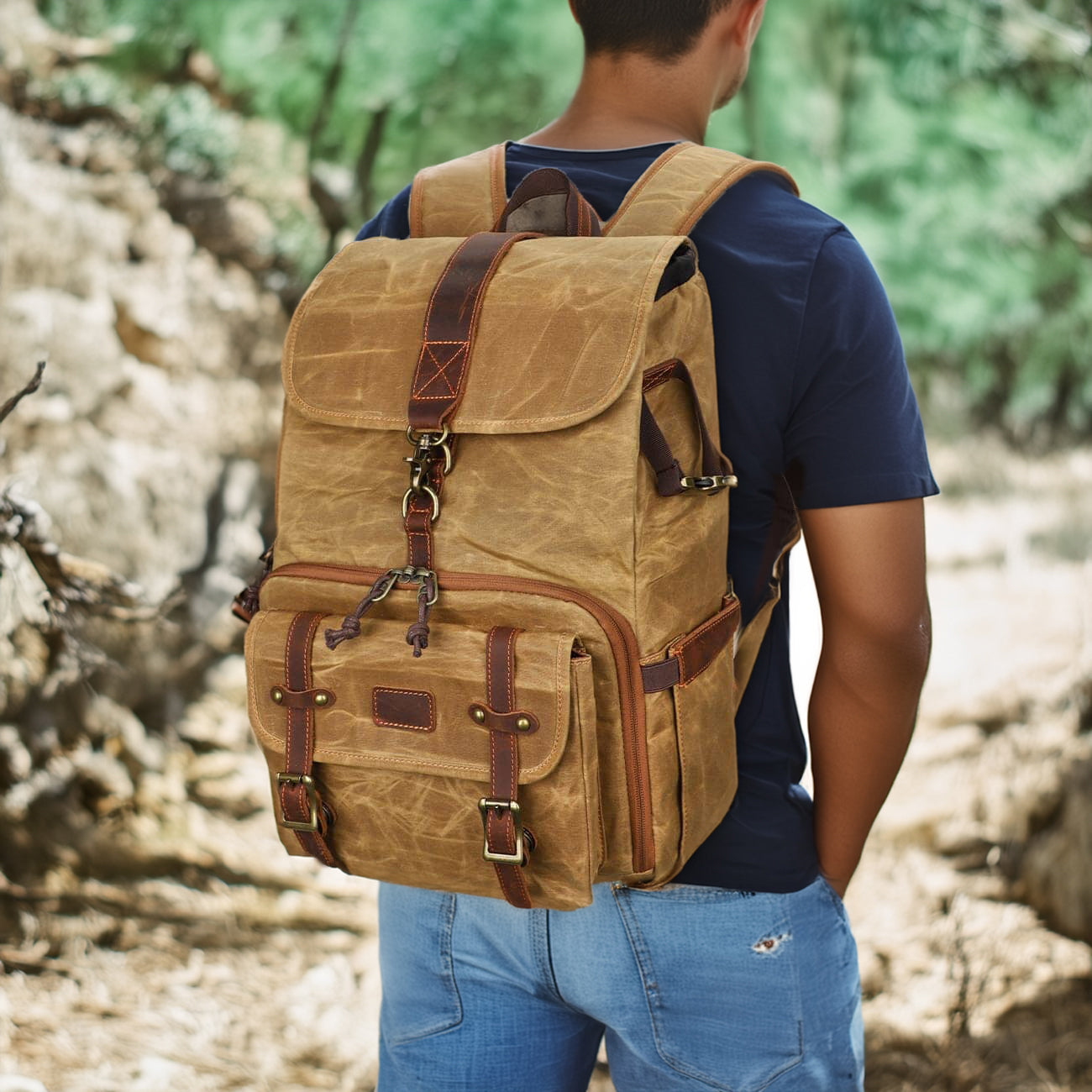 Man wearing a Kruger canvas camera backpack outdoors, showcasing its durable design and practical features.