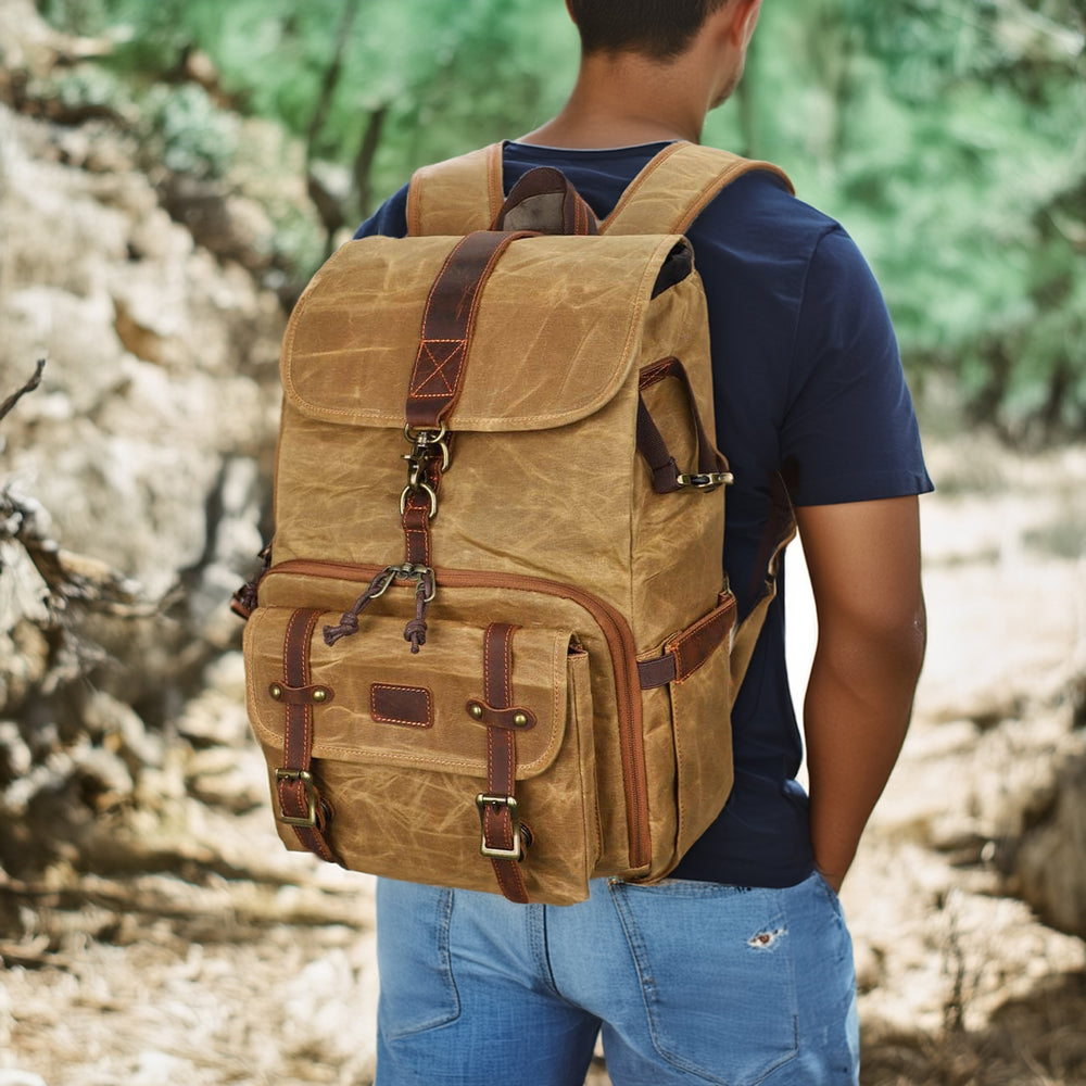 Man wearing a Kruger canvas camera backpack outdoors, showcasing its durable design and practical features.