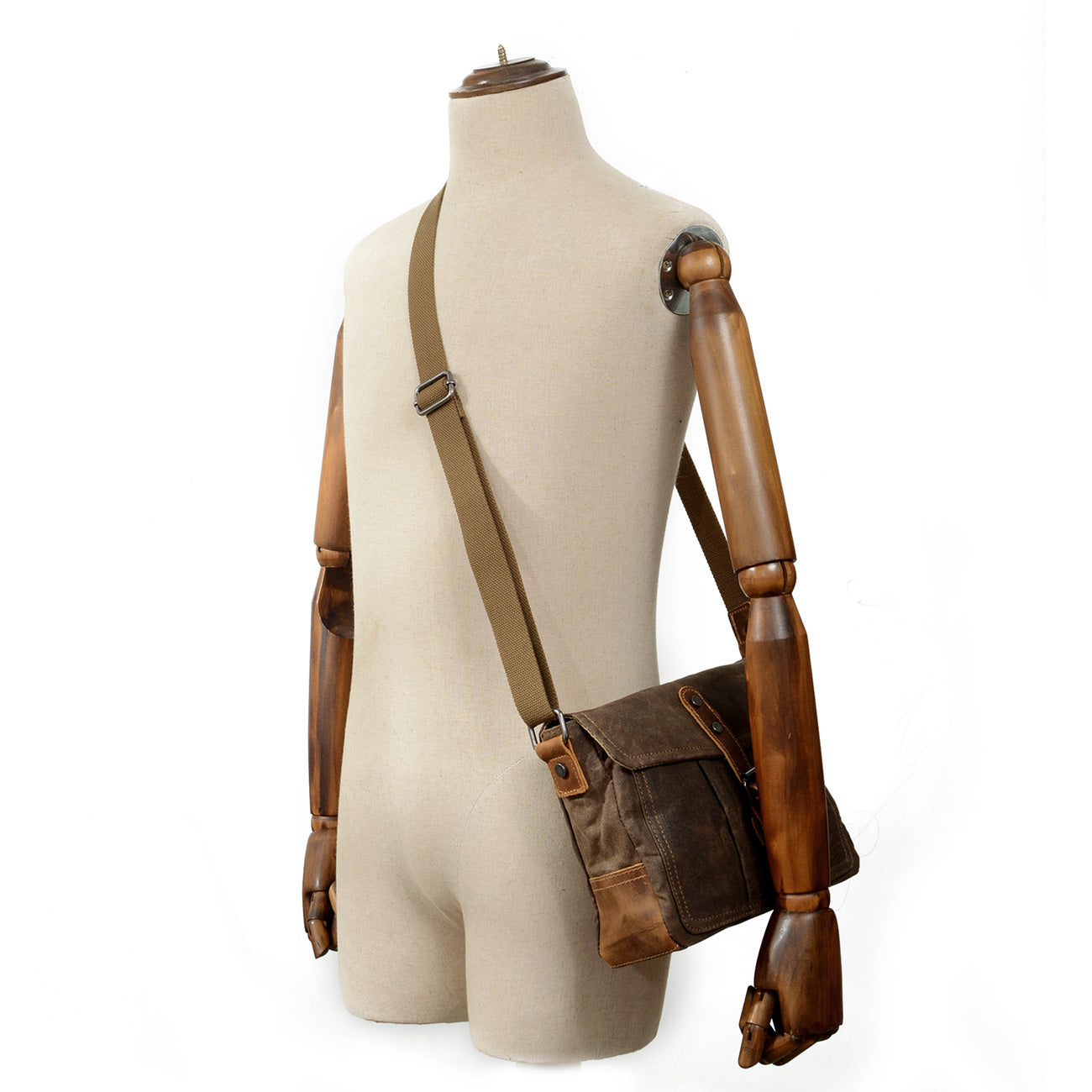 Small Canvas Messenger Bag by Pyrenees displayed on a mannequin, showcasing its stylish design and adjustable shoulder strap.