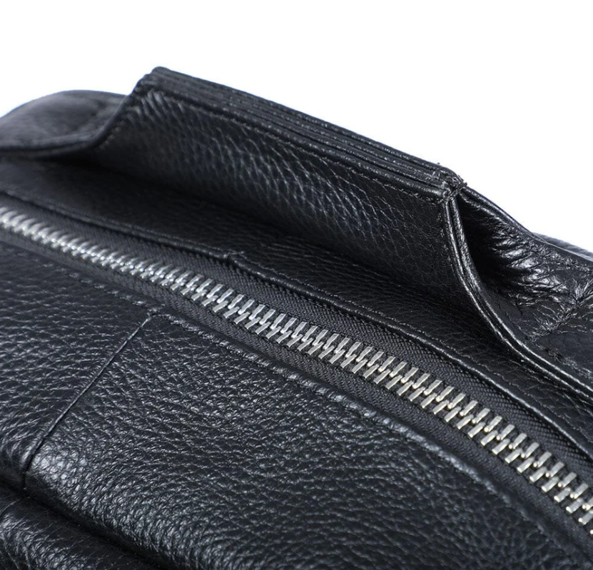 Close-up of the zipper and handle on a black leather bookbag from Death Valley.