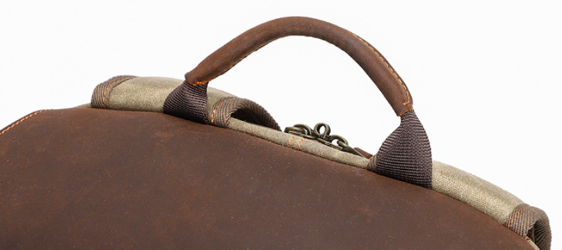 Close-up of Mount Aoraki camera backpack handle, showcasing premium leather and durable design for photography enthusiasts.