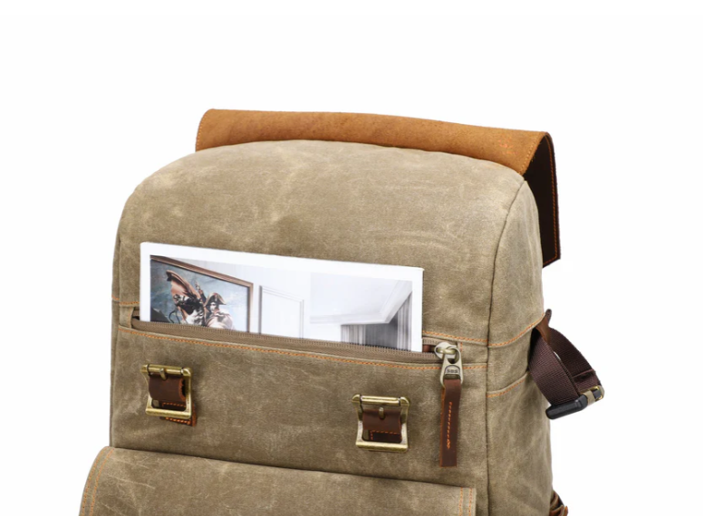 Camera backpack by Mount Aoraki with brown leather accents and a front pocket for photos.