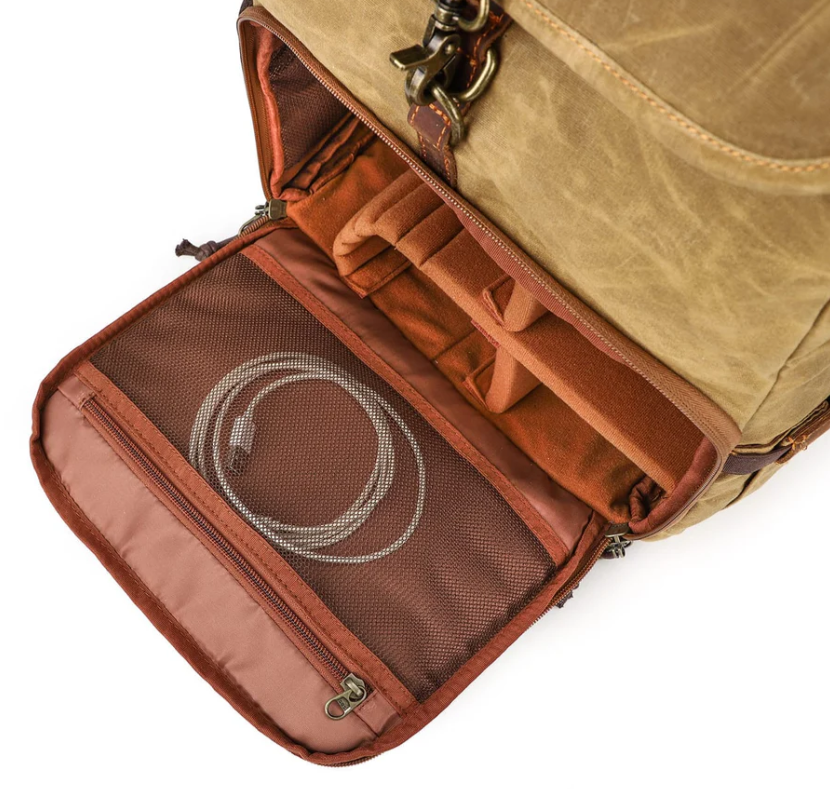 Interior view of Kruger canvas camera backpack, featuring organized compartments and a mesh pocket for accessories.