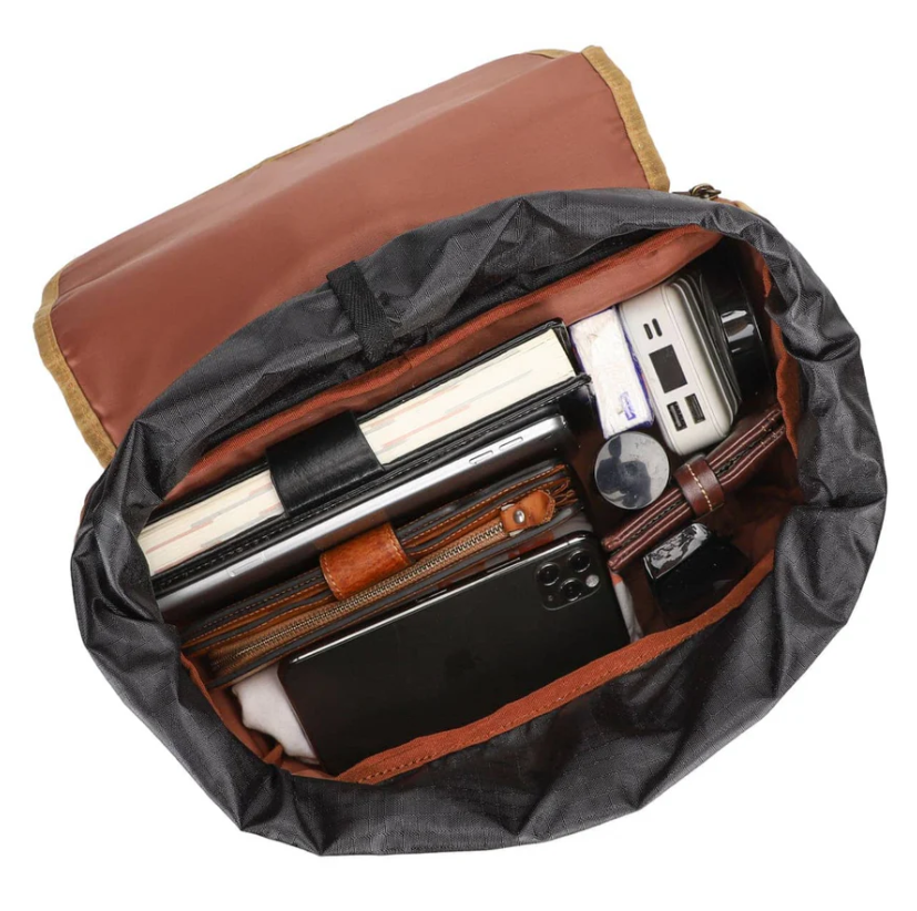 Interior view of the Canvas Camera Backpack by Kruger showcasing organized compartments for a camera, notebooks, and accessories.