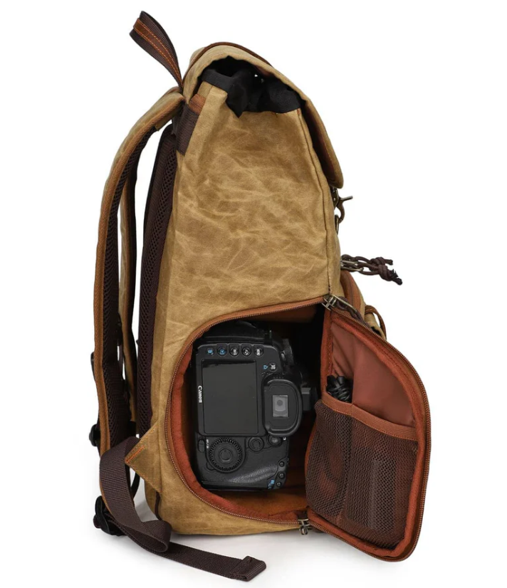 Canvas camera backpack Kruger featuring spacious interior and a camera secured in the side pocket.