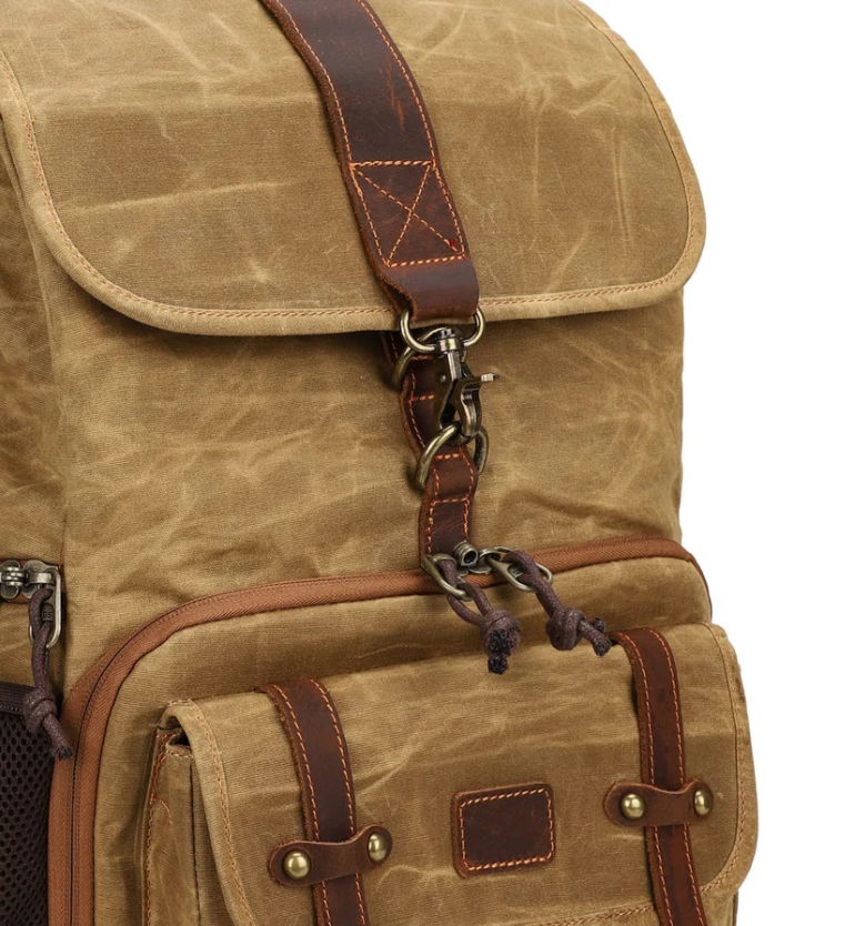 Close-up of the Kruger Canvas Camera Backpack showcasing its durable design and brown leather accents.
