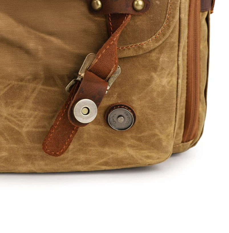 Close-up of the durable canvas and leather accents on the Kruger camera backpack.