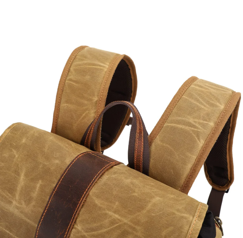 Detailed view of the Kruger Canvas Camera Backpack shoulder straps and top handle, showcasing its durable design.