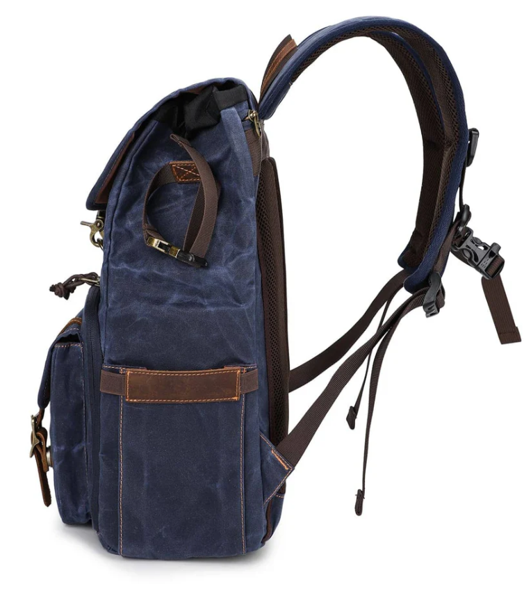 Side view of the Kruger canvas camera backpack featuring multiple compartments and padded straps.