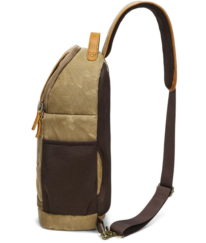 Side view of the Canvas Camera Sling Bag in khaki, featuring a padded strap and mesh pockets for easy access.