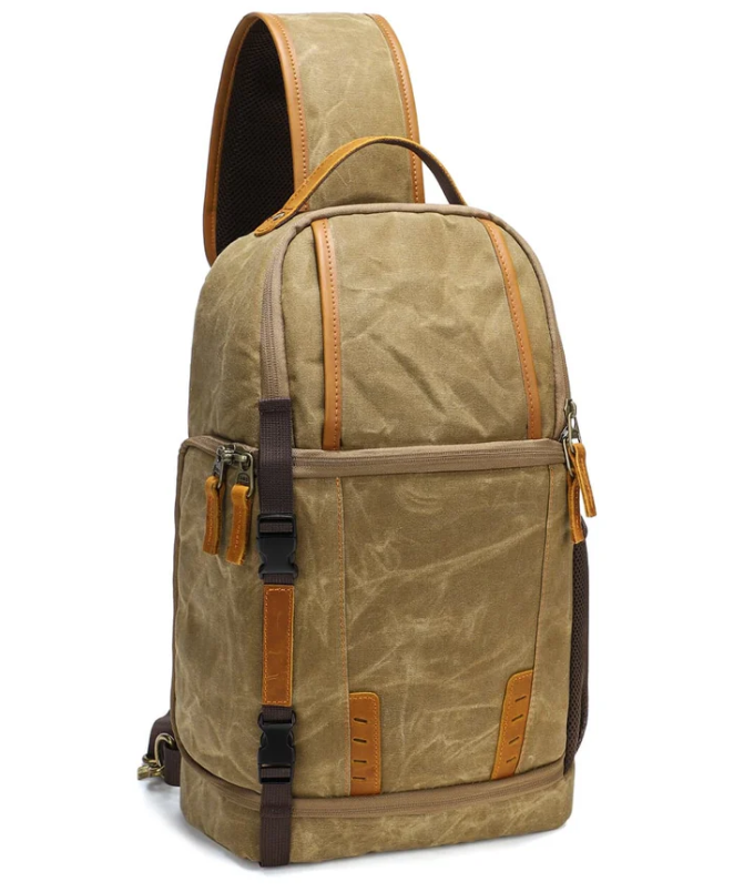 Canvas camera sling bag in a stylish tan with leather accents, ideal for travel and outdoor photography.