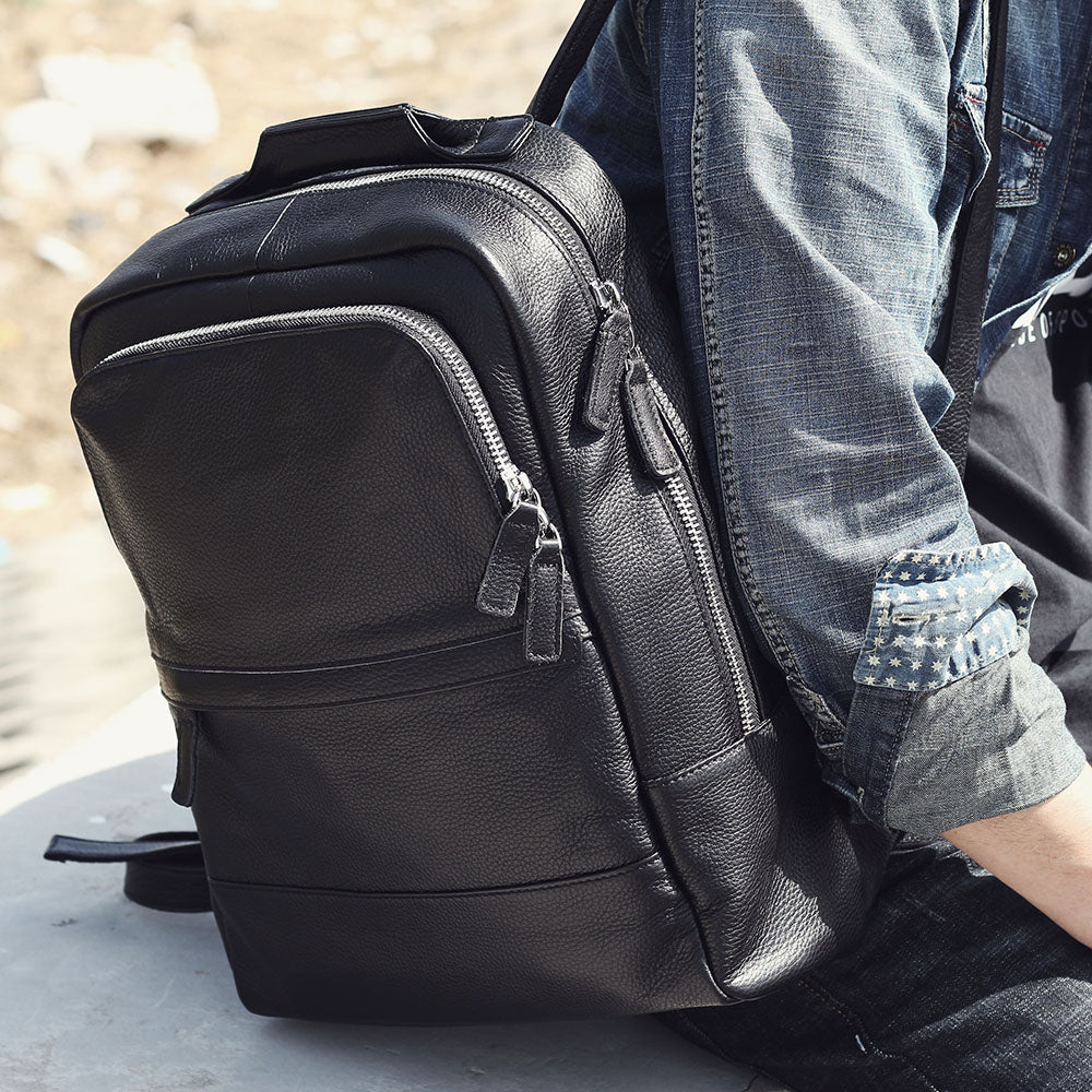 Stylish black leather bookbag featured against a casual outfit, perfect for fashion-forward individuals.