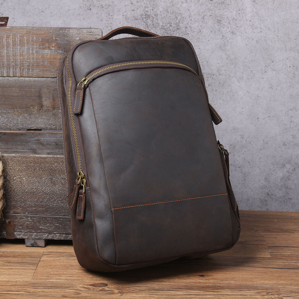 Stylish leather laptop rucksack in dark brown, featuring a sleek design and practical compartments for modern professionals.