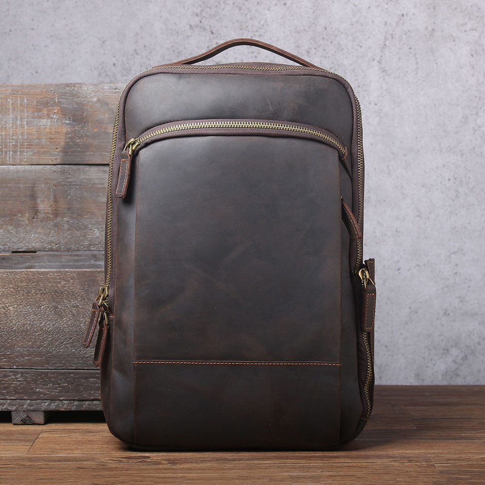 Stylish leather laptop rucksack in dark brown, perfect for work or travel, featuring multiple compartments and a sleek design.