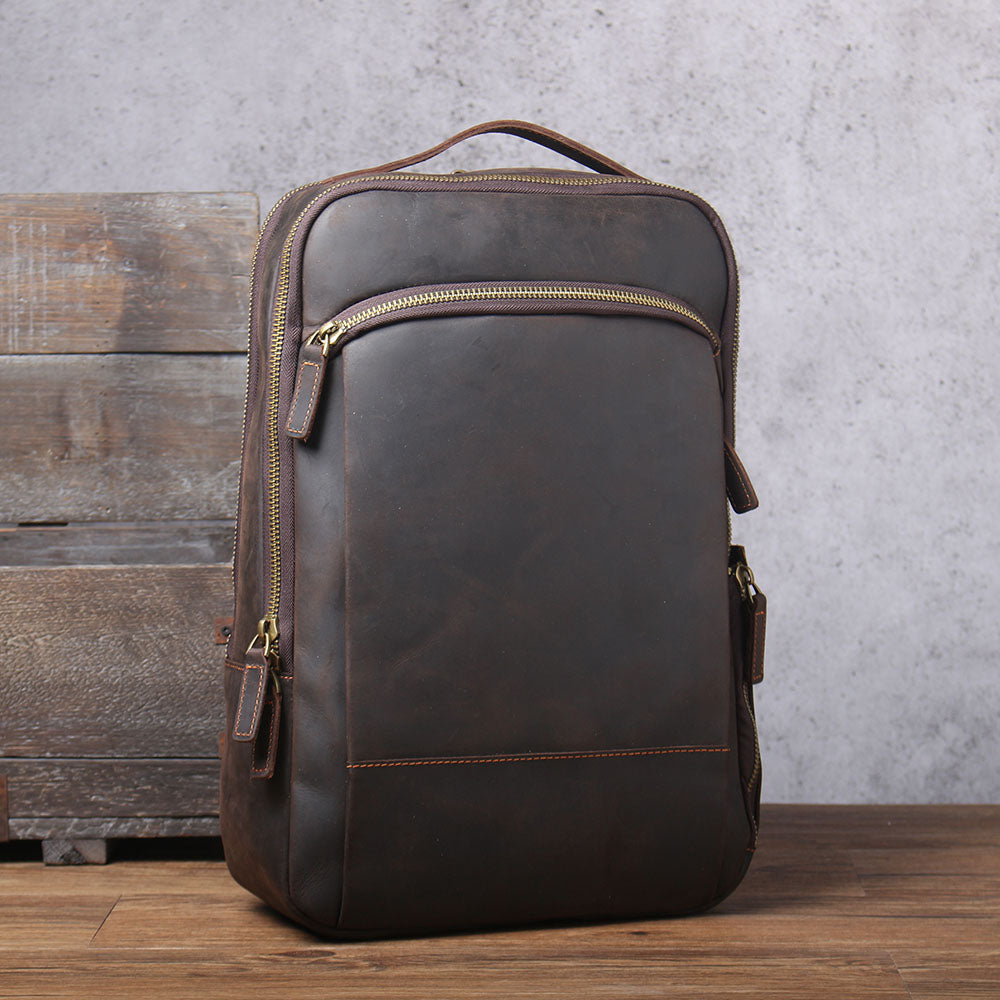 Stylish leather laptop rucksack in dark brown, perfect for daily use and travel, featuring multiple compartments.