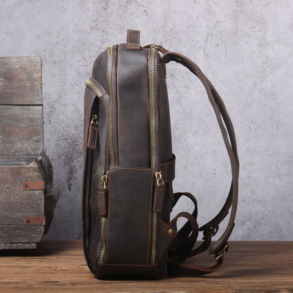 Leather Laptop Rucksack Loch Ness shown from side angle, featuring durable construction and multiple zippered compartments.