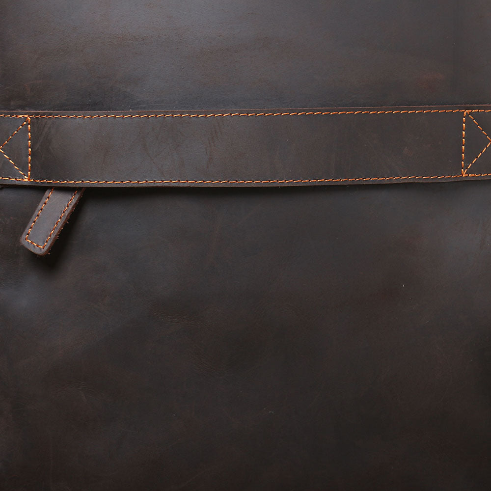 Close-up of the stylish leather strap detail on the Loch Ness leather laptop rucksack, showcasing premium craftsmanship.