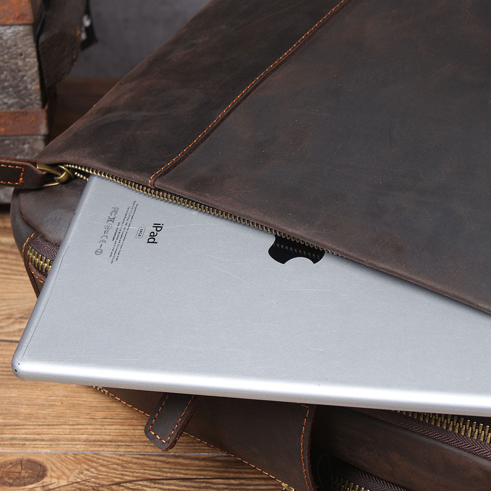 Close-up of a leather laptop rucksack showing an iPad inside, highlighting the bag's spacious design.