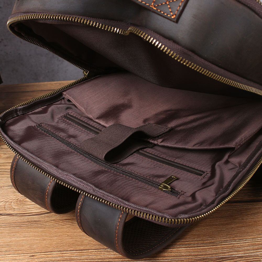 Interior view of a leather laptop rucksack, featuring pockets and a spacious compartment for organization.