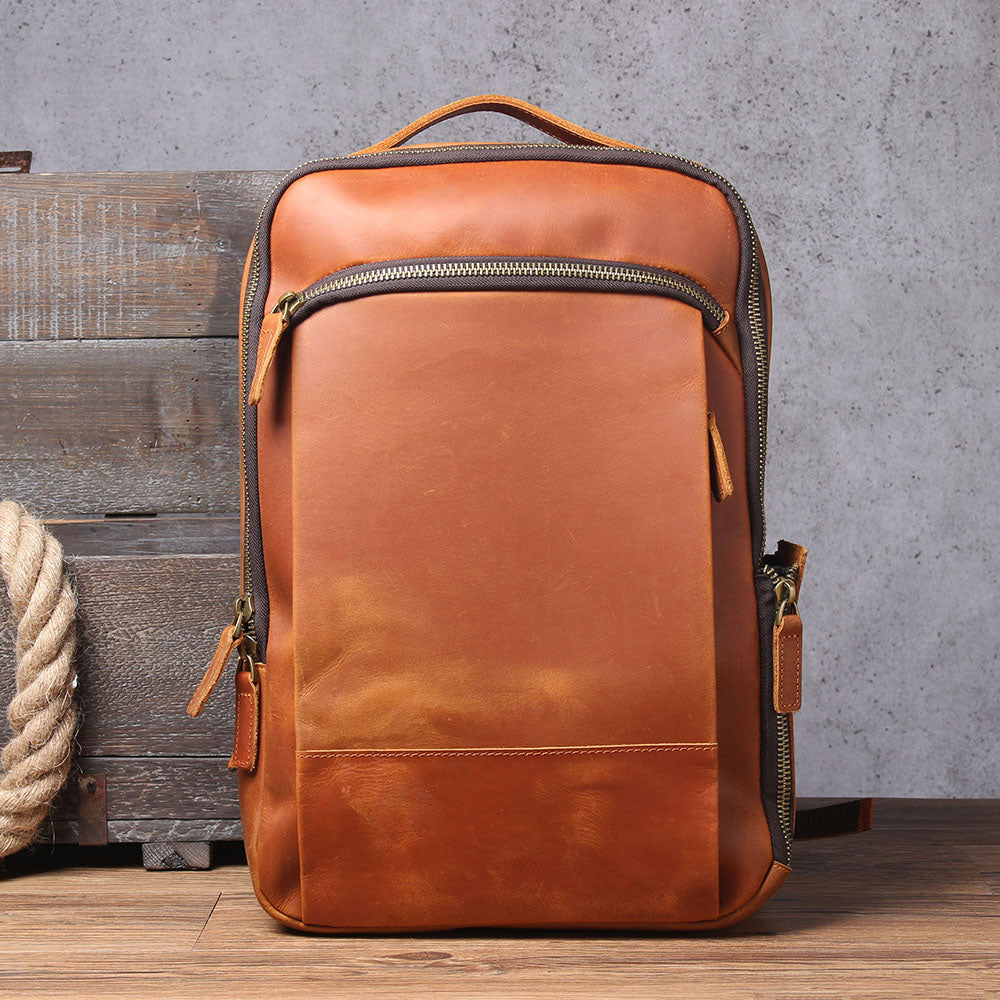 Stylish leather laptop rucksack in brown, featuring a clean zipper design and adjustable straps, perfect for daily use.