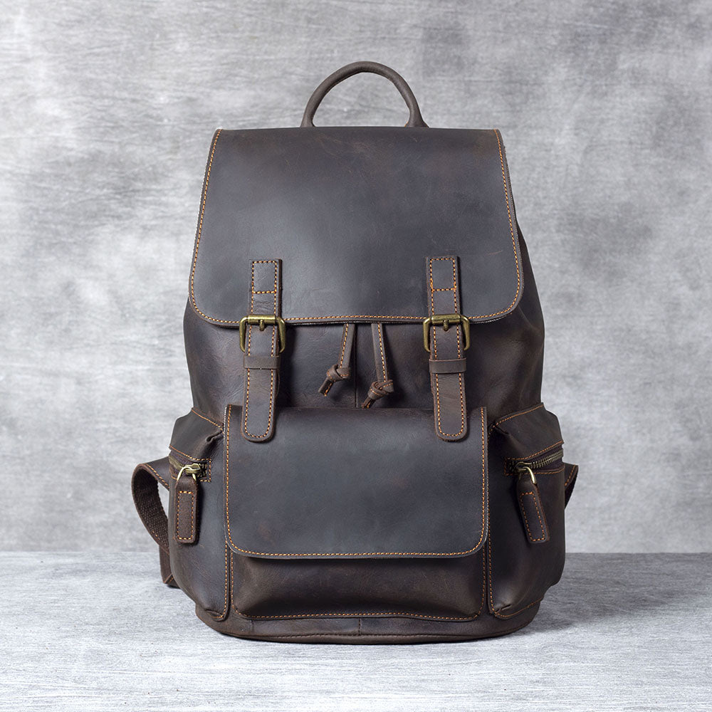 Leather drawstring backpack in dark brown with stylish details and multiple pockets for convenience.