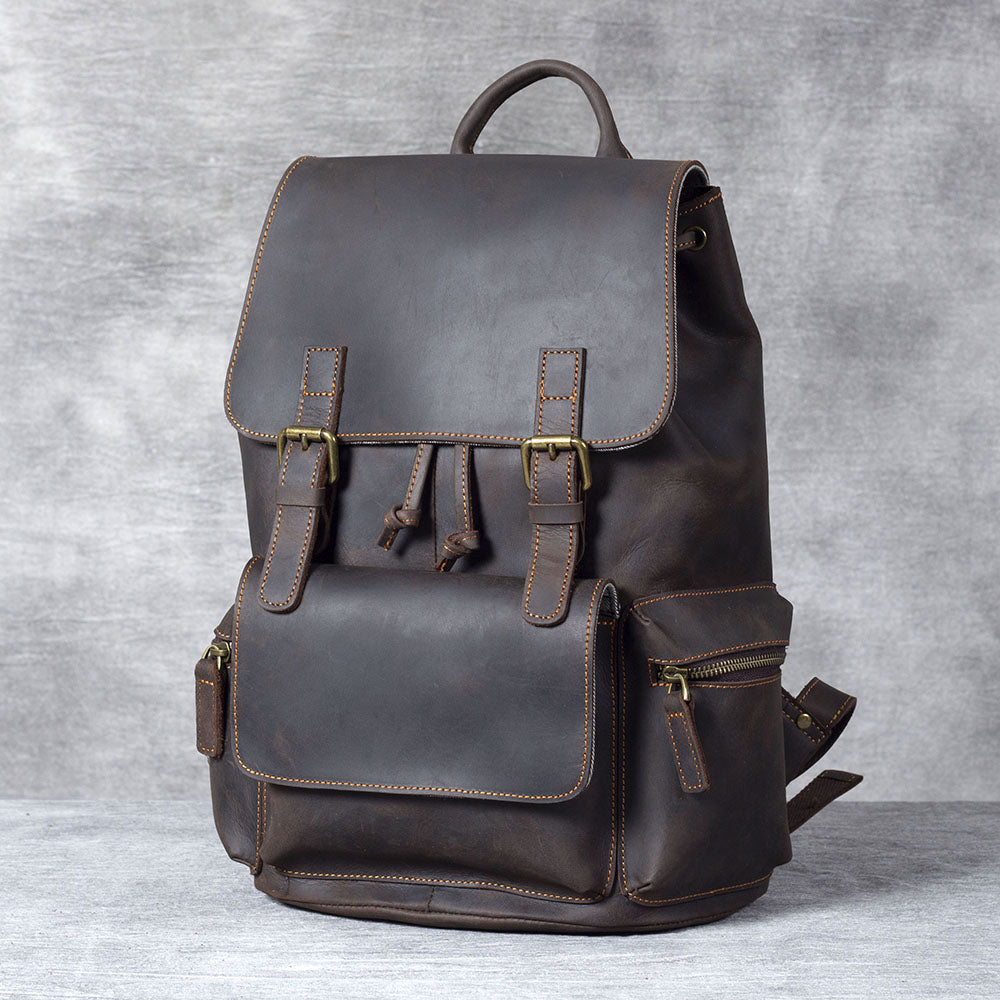 Handcrafted black leather drawstring backpack with sleek design and multiple pockets for versatility and style.