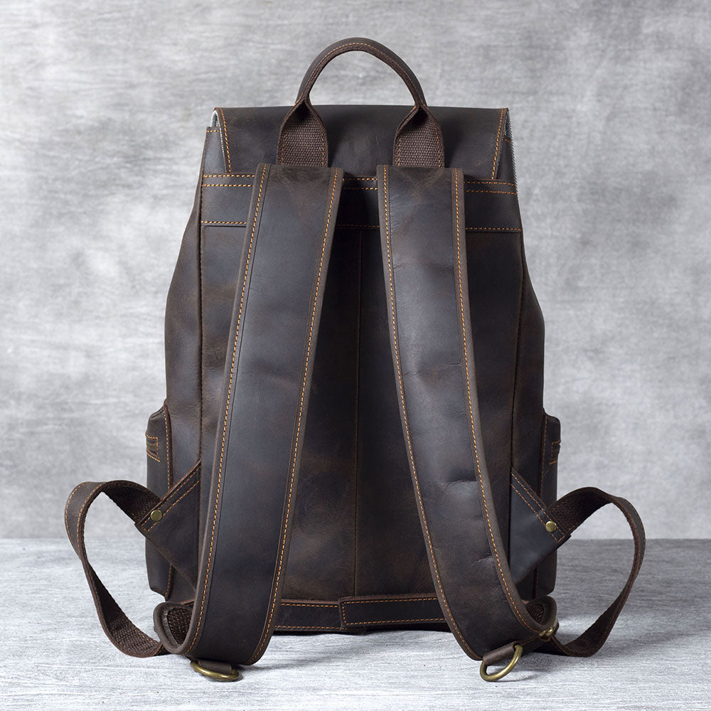 Back view of a stylish black leather drawstring backpack showcasing padded straps and a sleek design.