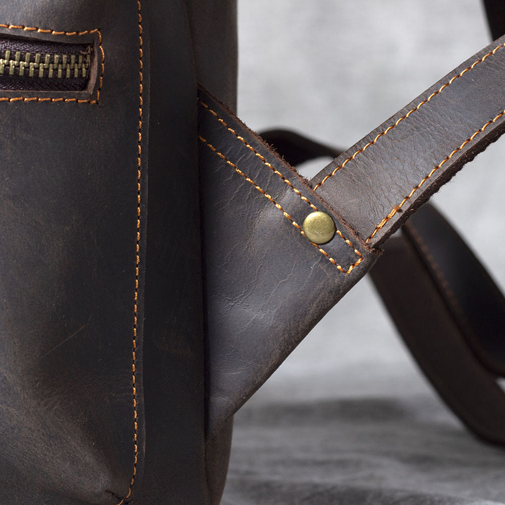 Close-up of the leather drawstring backpack showcasing the stitching and hardware detailing.
