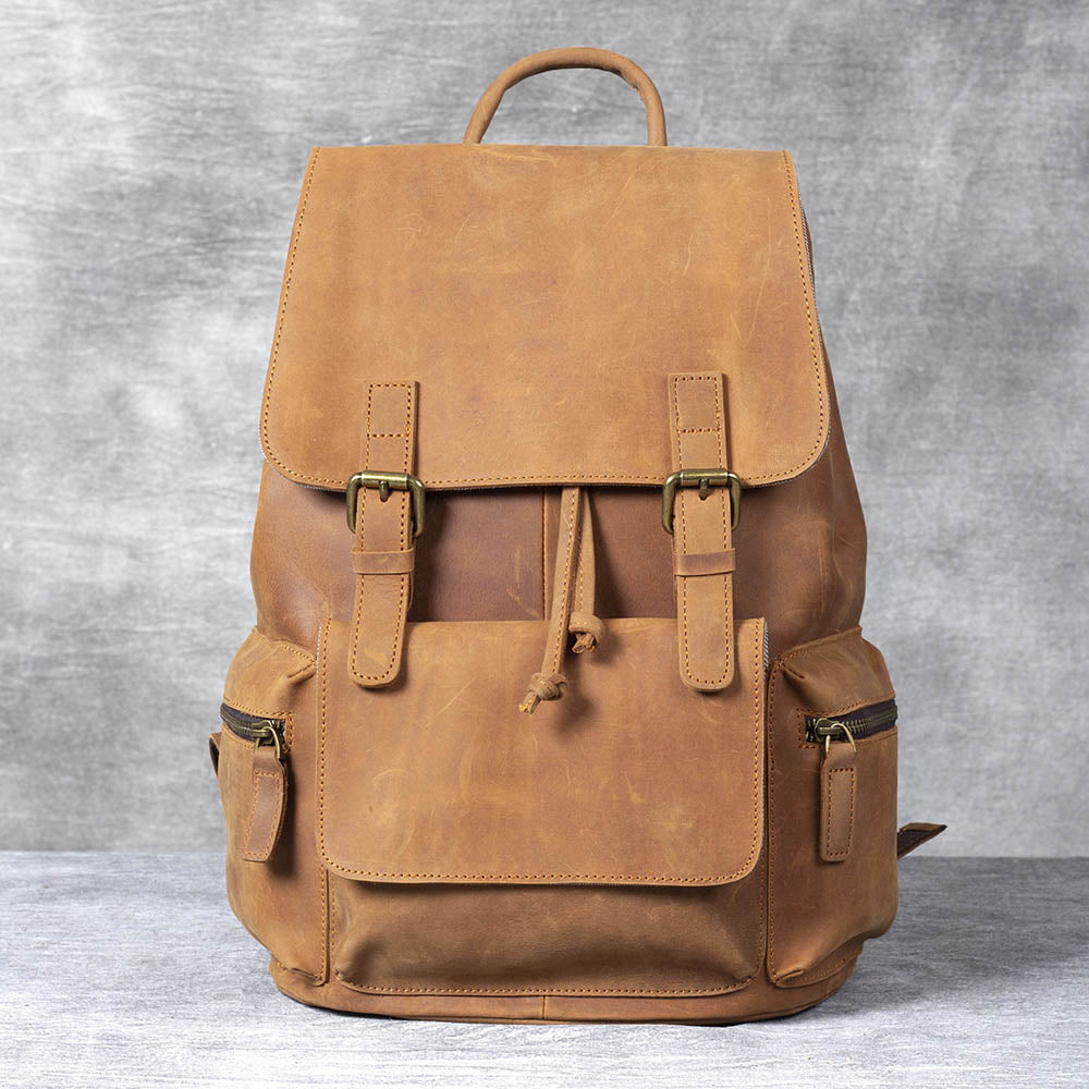 Stylish brown leather drawstring backpack with multiple pockets and adjustable straps, perfect for everyday use.