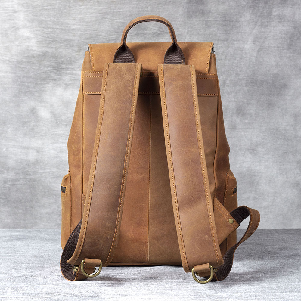 Leather drawstring backpack in brown leather showcasing adjustable straps and stylish design.
