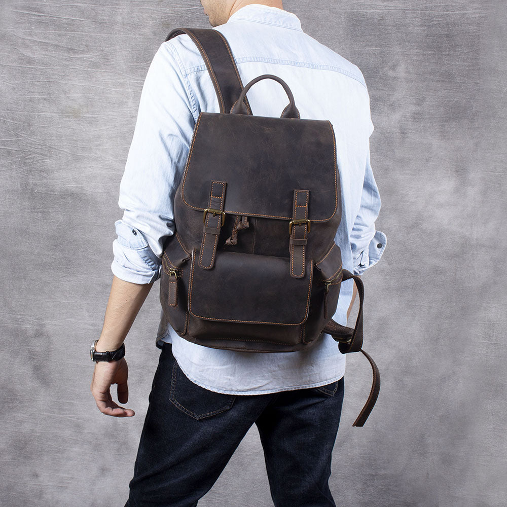 Brown leather drawstring backpack worn on the back, perfect for daily use and stylish outings.