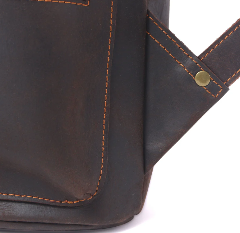 Close-up of the Leather Drawstring Backpack in black with contrasting orange stitching and brass accents.