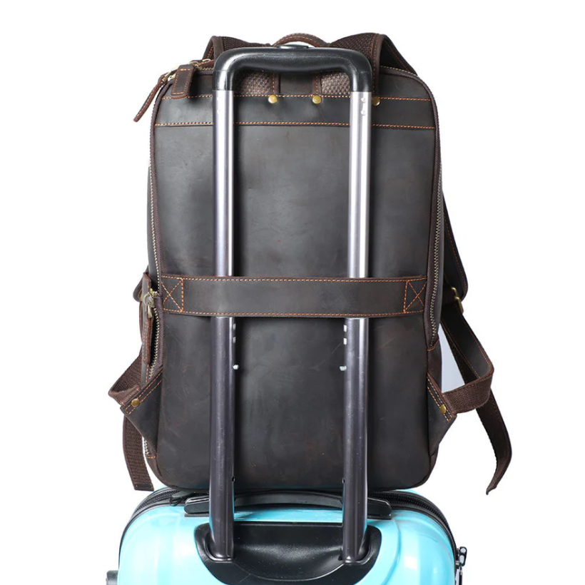 Leather laptop rucksack Loch Ness displayed on a suitcase, showcasing its durable design and travel convenience.