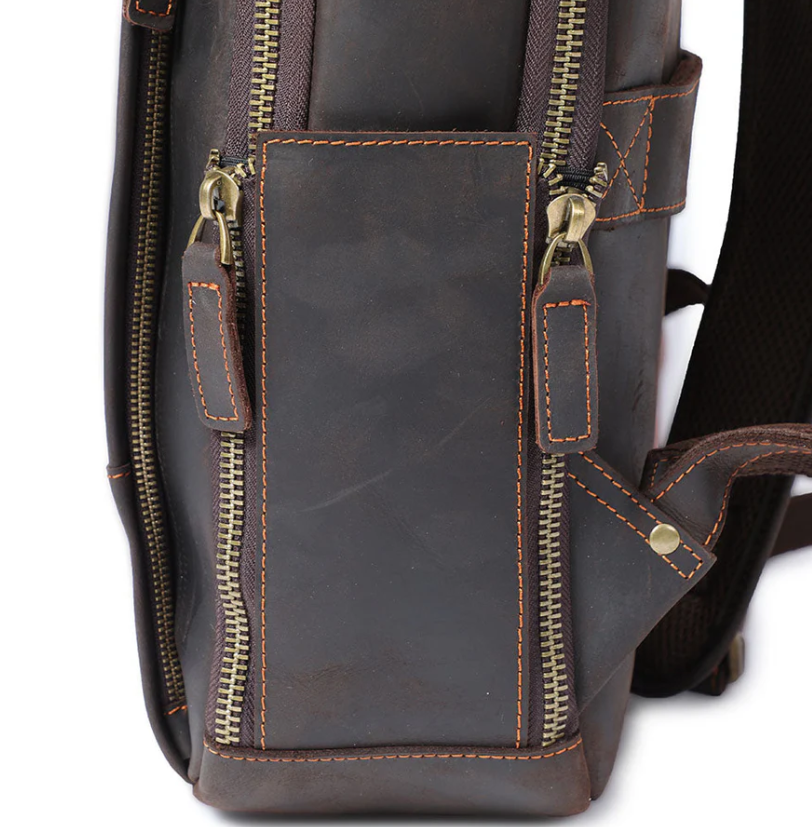 Close-up of the brown leather side of the Loch Ness laptop rucksack showcasing zipper details.