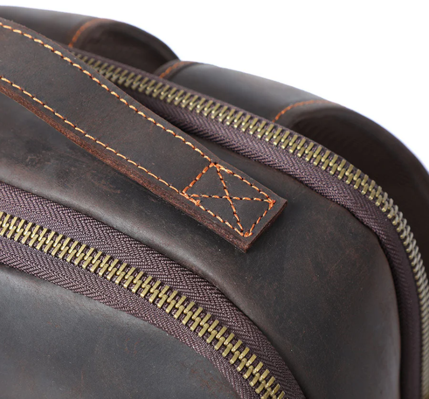 Close-up of the leather zipper and handle of the Loch Ness Leather Laptop Rucksack, showcasing its quality craftsmanship.