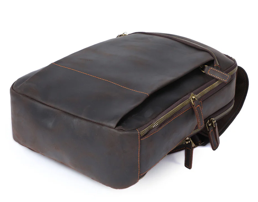 Stylish leather laptop rucksack in brown with zip closures, ideal for modern professionals and students.