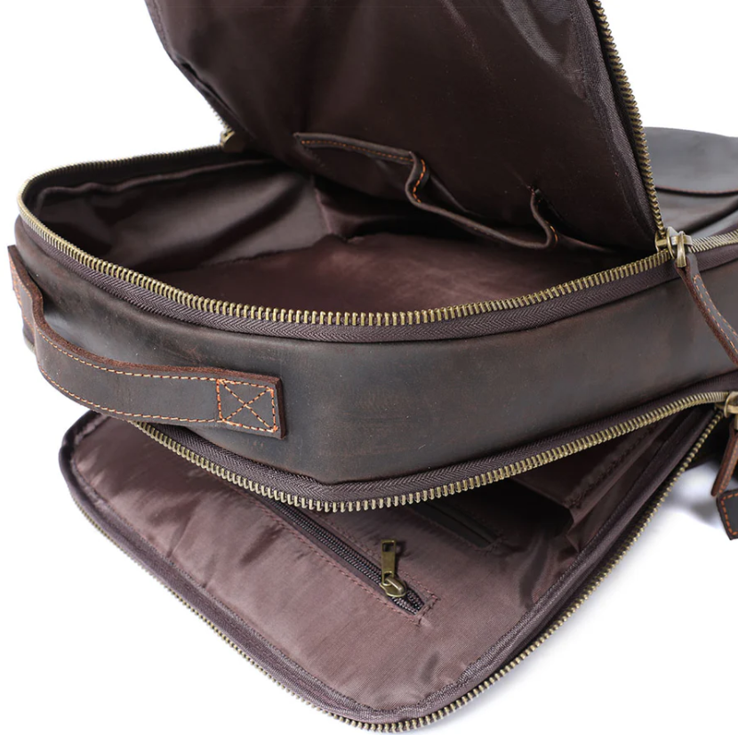 Interior view of the Leather Laptop Rucksack Loch Ness, showcasing pockets and zippers for organization.